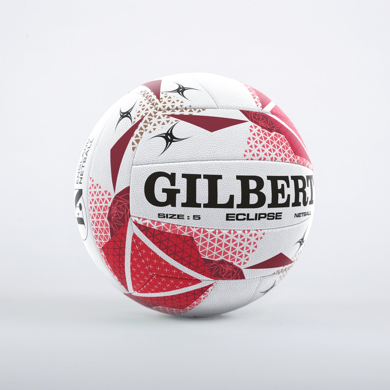 The Gilbert Eclipse England Netball sz5 is a white netball with red and black geometric patterns, featuring dura grip technology and the Gilbert brand name. The size 5 details are printed clearly on the ball, shown against a light grey background.