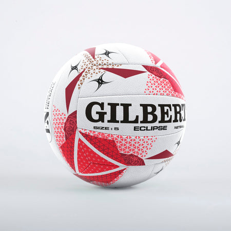 The Gilbert Eclipse England Netball sz5 is a white netball with red and black geometric patterns, featuring dura grip technology and the Gilbert brand name. The size 5 details are printed clearly on the ball, shown against a light grey background.