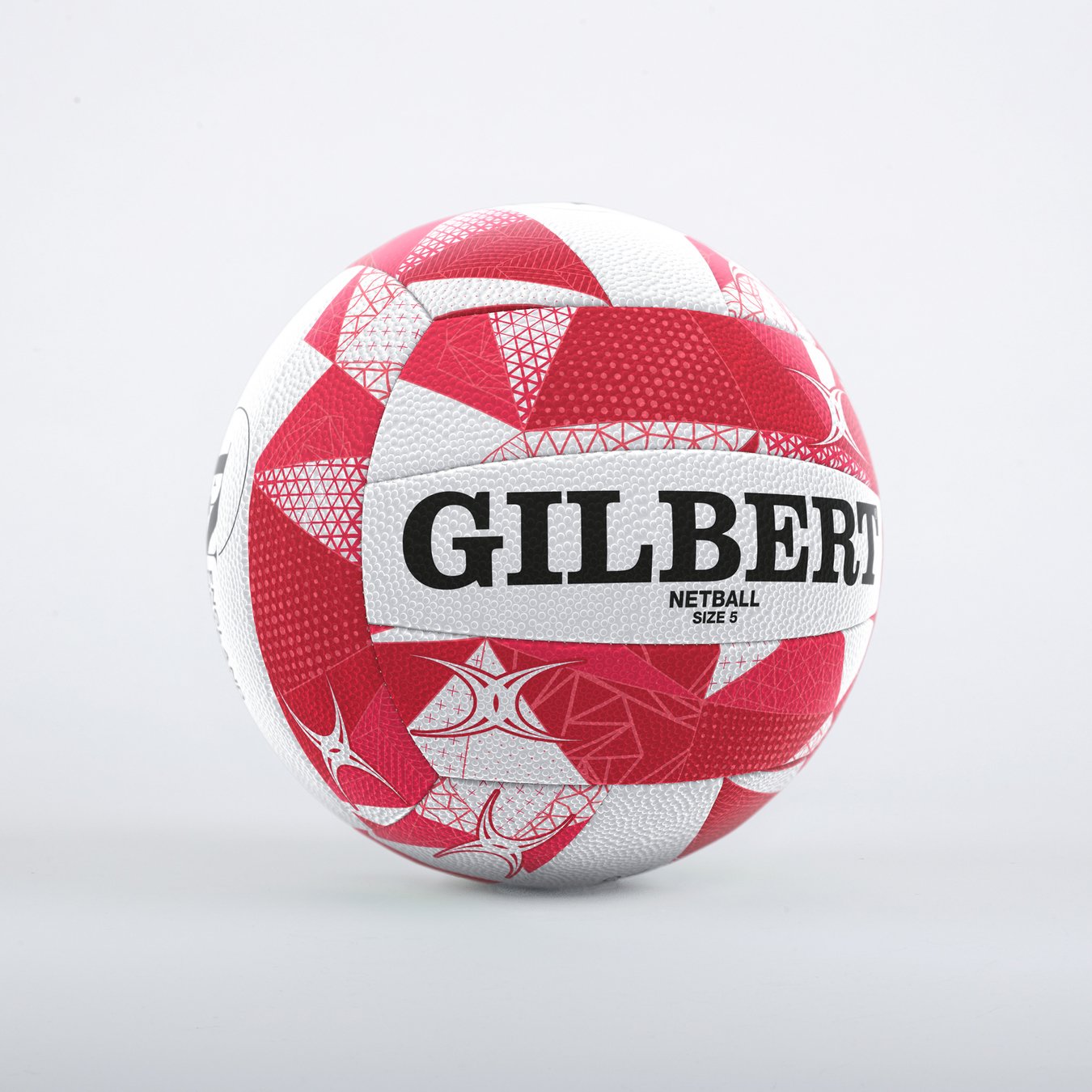 A Gilbert England Supporters Netball SZ5 by Gilbert, featuring a red and white pattern with bold black lettering, is displayed on a plain light gray background.