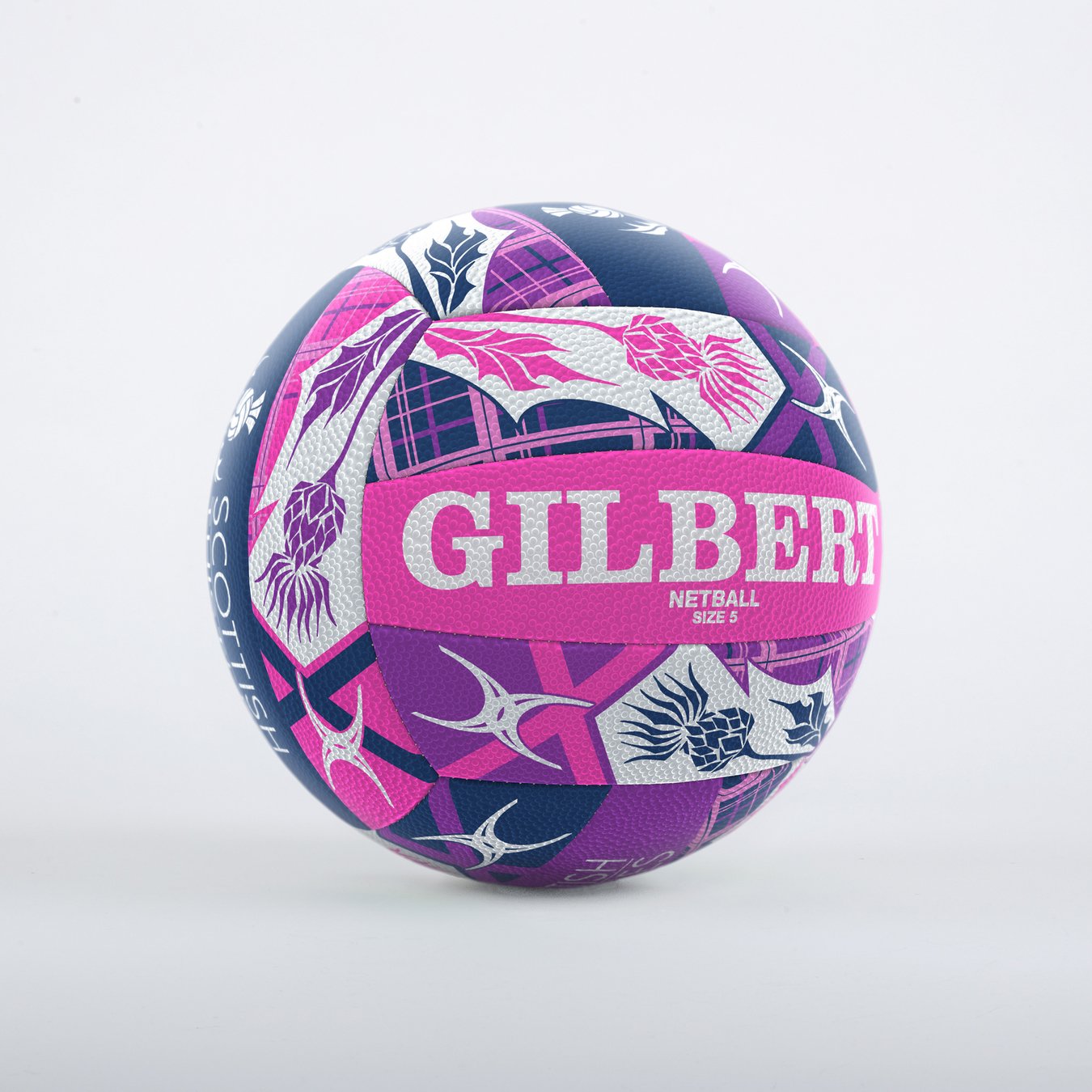 The Gilbert Scotland Supporter Netball is a vibrant Size 5 ball featuring bold pink, purple, and navy geometric and floral designs, with "GILBERT" displayed prominently in large white letters.