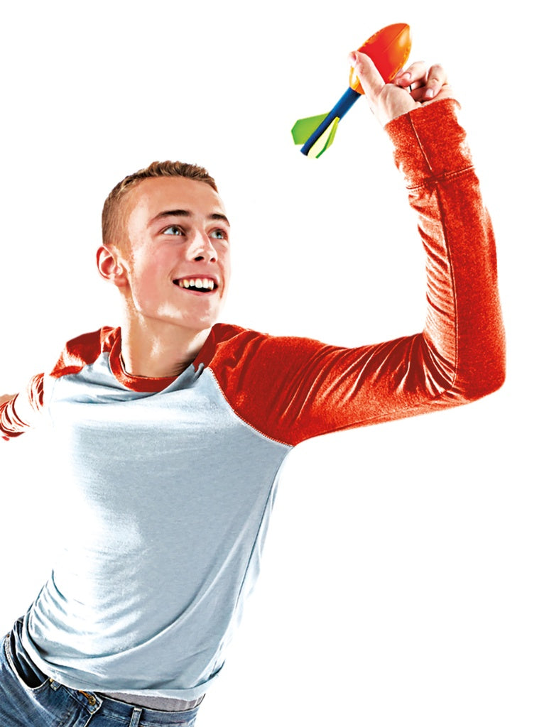 A smiling young person in a light blue shirt with red sleeves holds up a colorful Nerf Pocket Vortex Howler by Nerf, ready to throw it for long-distance football fun. The background is white.