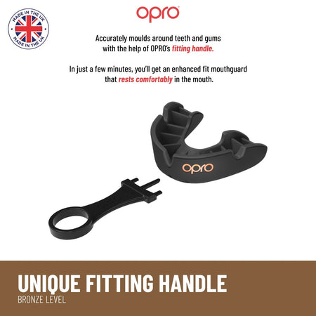 A black OPRO Bronze Self Fit Mouthguard and black fitting handle by Opro are shown on a white background. Text highlights its comfortable fit and teeth protection, with a “Made in the UK” badge in the top left corner.