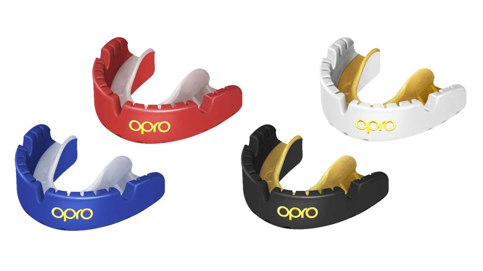 The OPRO Gold Braces Self-Fit Mouthguard by Opro in Red/White features a contrasting inner color and front OPRO logo, providing premium protection for braces as a top competition gum shield.