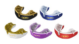 The OPRO Gold Self-Fit Mouthguard by Opro, shown in red and white, features antimicrobial protection and displays the OPRO brand name against a white background.