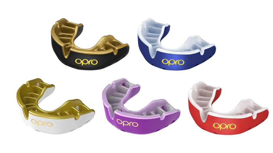 The OPRO Gold Self-Fit Mouthguard by Opro, shown in red and white, features antimicrobial protection and displays the OPRO brand name against a white background.