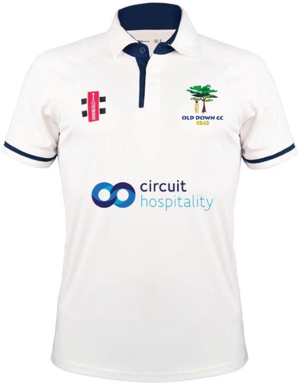 The Gray Nicolls Old Down CC Pro Performance V3 S/S Cricket Shirt features a white design with navy trim, anti-UV fabric, Old Down CC 1845 and sponsor logos, plus a navy collar with a button placket.