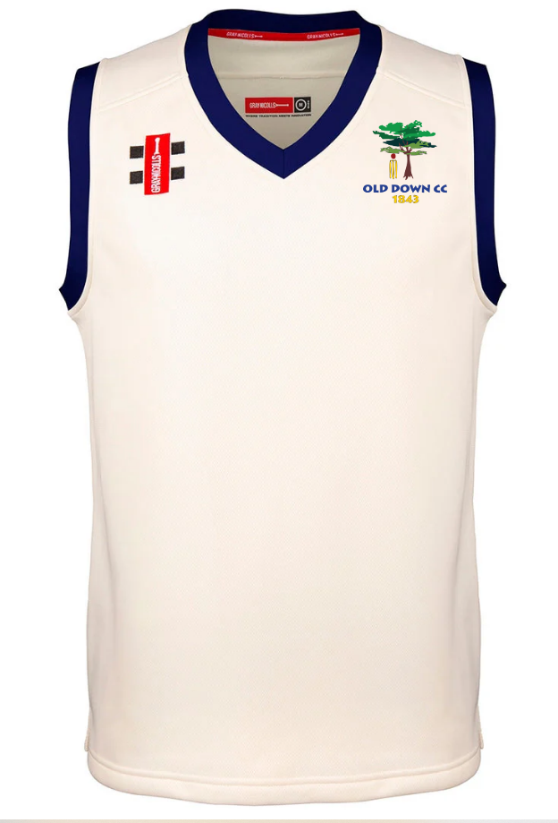 The Old Down CC Pro Performance Slipover by Gray Nicolls is a sleeveless white top with navy trim, featuring the club logo and text, red sponsor patch, black checkered chest logo, and advanced wicking for comfort.