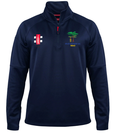 The Gray Nicolls Old Down CC Pro Thermo Fleece is a navy quarter-zip pullover with a red zipper, club logo and "1843" on the left chest, plus a red patch with white cricket stumps on the right chest for extra style and warmth.