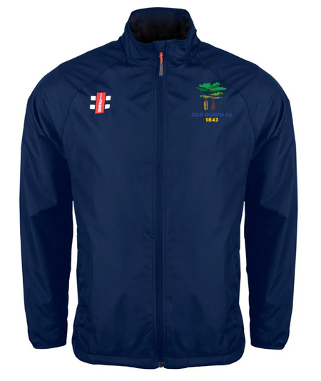 Stay dry in unpredictable weather with the Gray Nicolls Old Down CC Velocity Rain Jacket, featuring a navy blue design, cricket bat logo on the right chest, and green tree with yellow OLD DEAN CC 1847 text on the left.