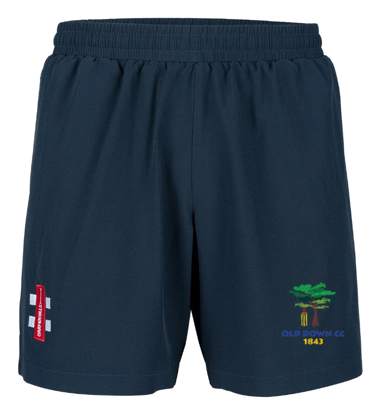 Old Down CC Velocity Shorts by Gray Nicolls—navy blue with elastic waistband, red and white logo on the left thigh, green tree Old Down CC 1843 emblem on the right. Four-way stretch fabric delivers maximum comfort for training.