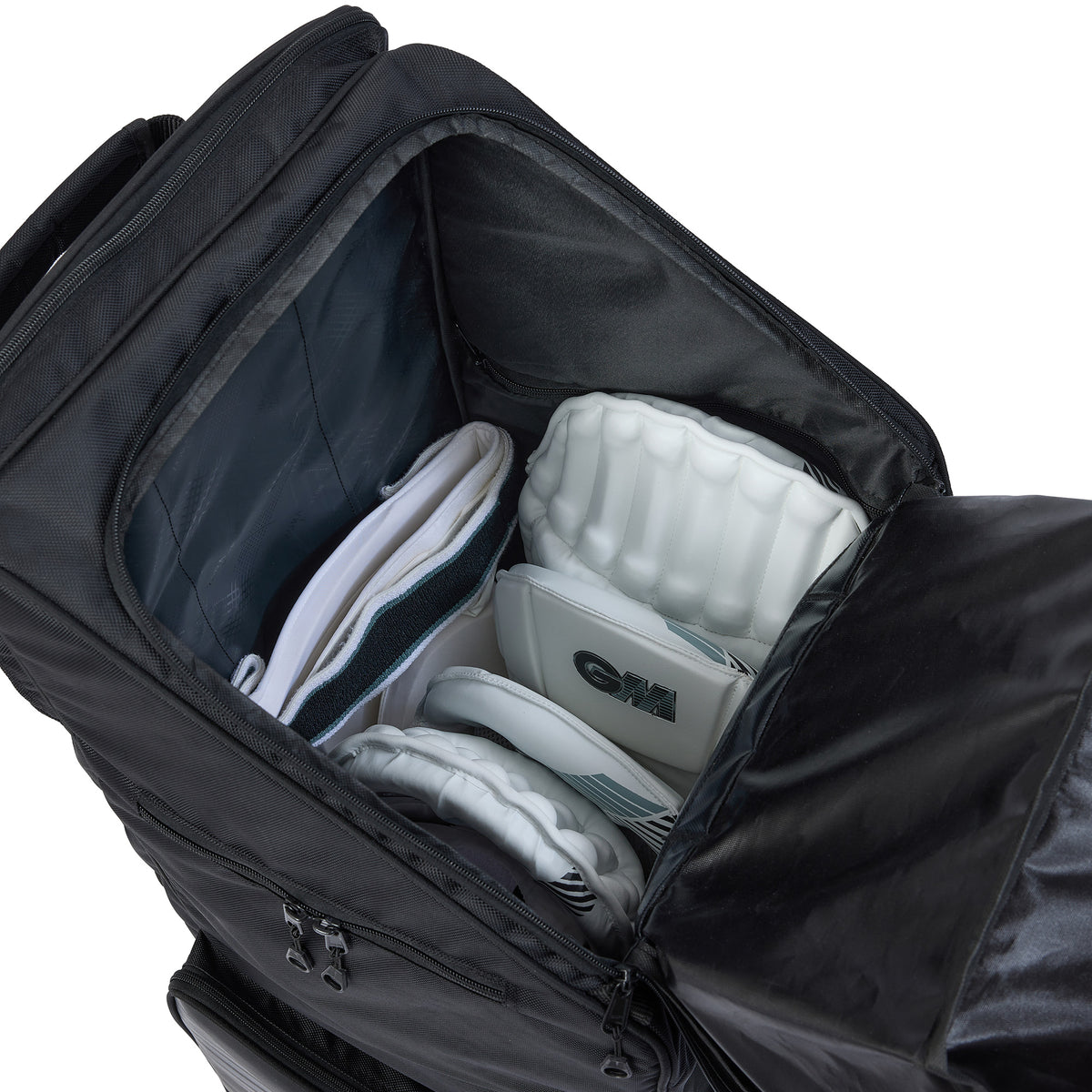 A Gunn & Moore Players Edition Duffle Bag 2026 by Gunn & Moore is unzipped and open, showing white cricket batting pads and gloves neatly arranged in customizable compartments, with space left for a bat, as seen from above.