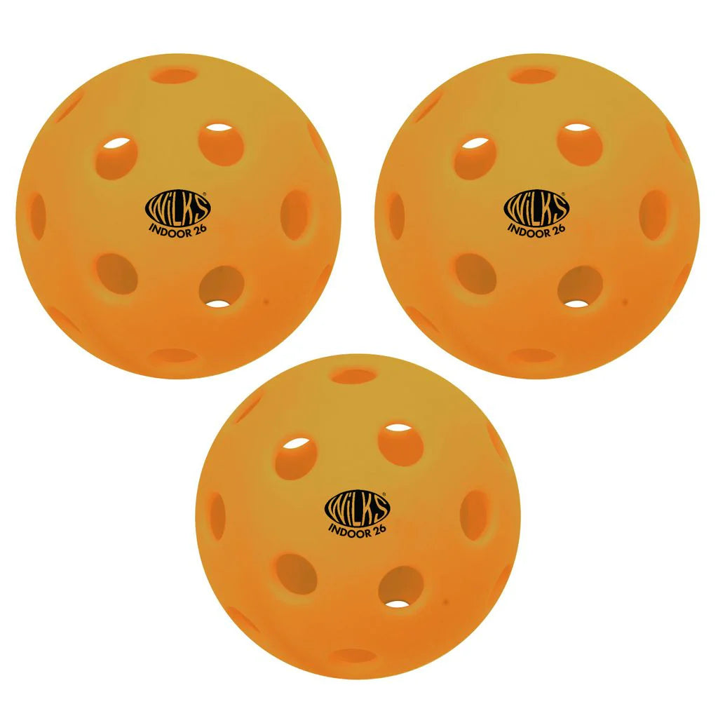 Three orange Wilks Wilkes Indoor Pickleball 26 holes balls, each featuring the black INDOOR 26 logo and multiple holes, are arranged in a triangular formation on a white background.
