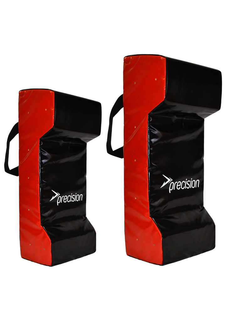 Two rectangular Precision Training Double Wedge Hit Shields in black and red, with handles and "precision" printed in white, stand upright side by side in different sizes—ideal rugby training equipment for tackling practice.