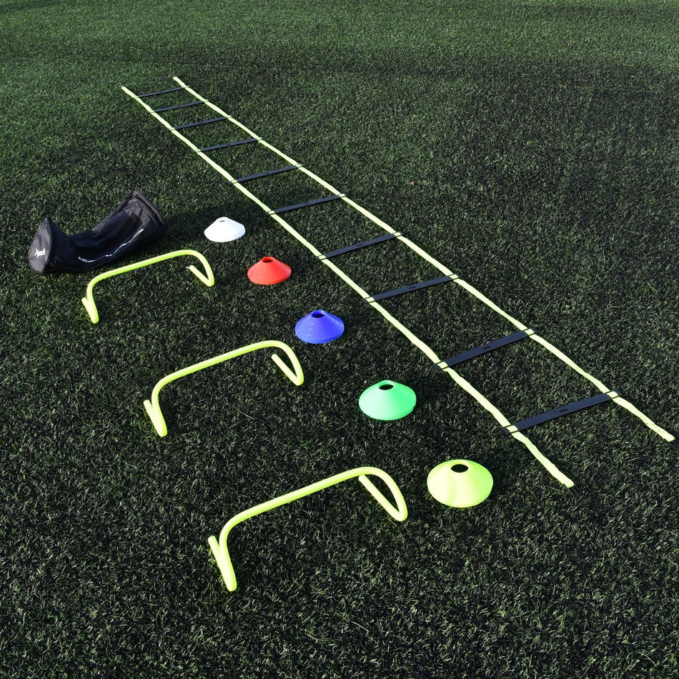 The Precision Coach Training Set by Precision Training includes a black bag, white cone, three yellow mini hurdles, multicolored cones, and an agility ladder—perfect for speed training and agility drills on artificial turf.