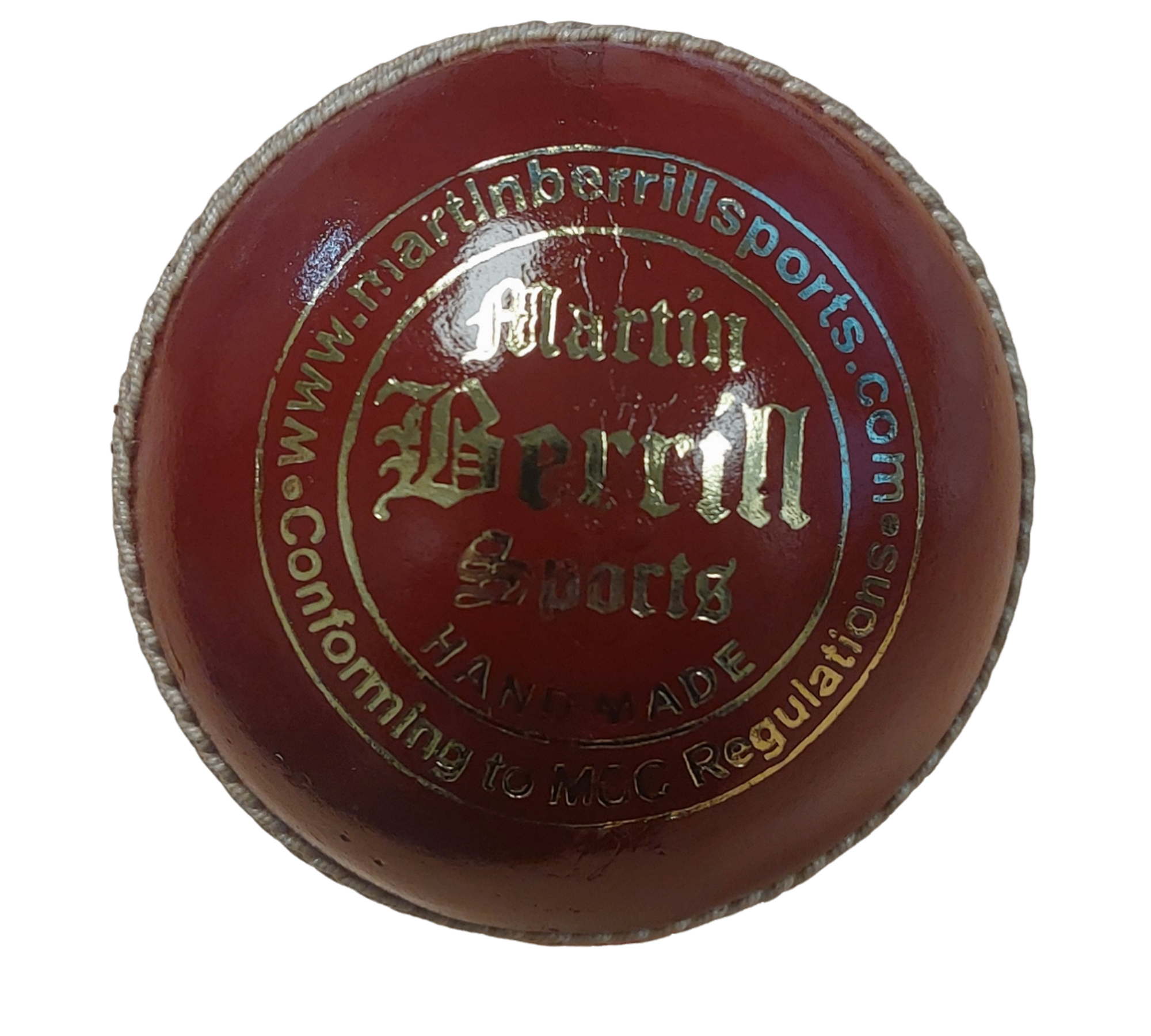 A close-up of the MBS Platinum Crown Cricket Ball by Martin Berrill Sports, made from English Alum Tanned Leather, with gold “Martin Berrill Sports” text, “Conforming to MCC Regulations,” and visible hand-stitched seams.
