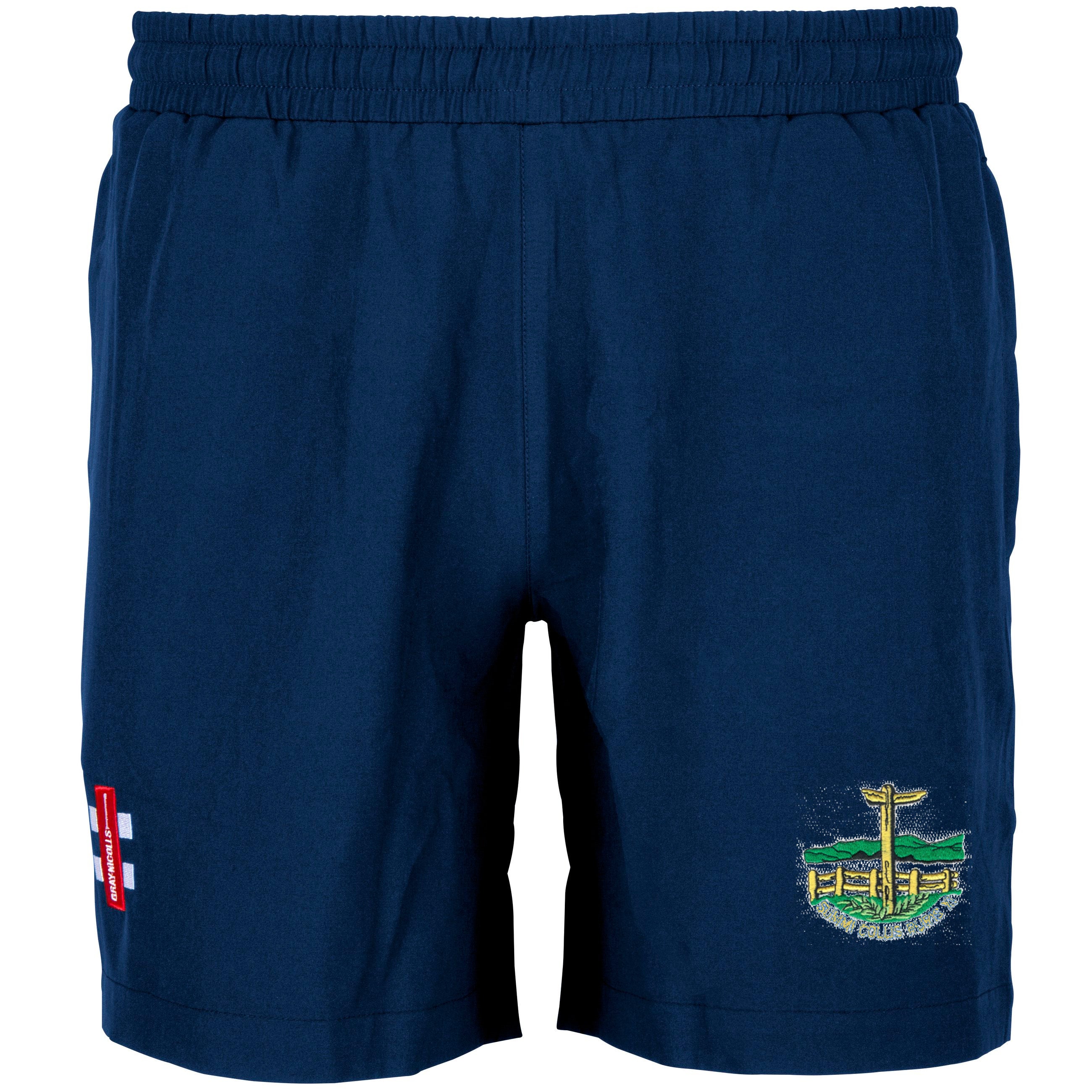 Gray Nicolls Penydarren Country XI CC Velocity Training Shorts in navy blue feature an elastic waistband, a small embroidered club crest with building and cross on the lower right leg, and an England flag patch on the lower left leg.