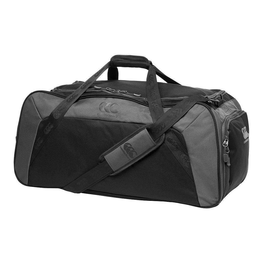 The Canterbury Classic Holdall Bag is a black waterproof gym bag with a zippered main compartment, two side pockets, carrying handles, an adjustable shoulder strap, and features the Canterbury logo.