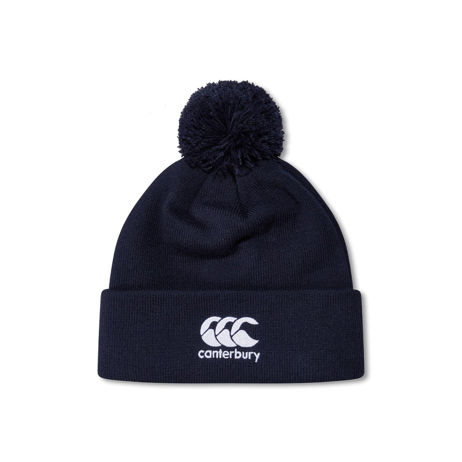 The Canterbury Club Bobble Hat by Canterbury is a navy fleece-lined hat with a pom-pom, folded brim, and white embroidered logo on the front—an ideal winter accessory.