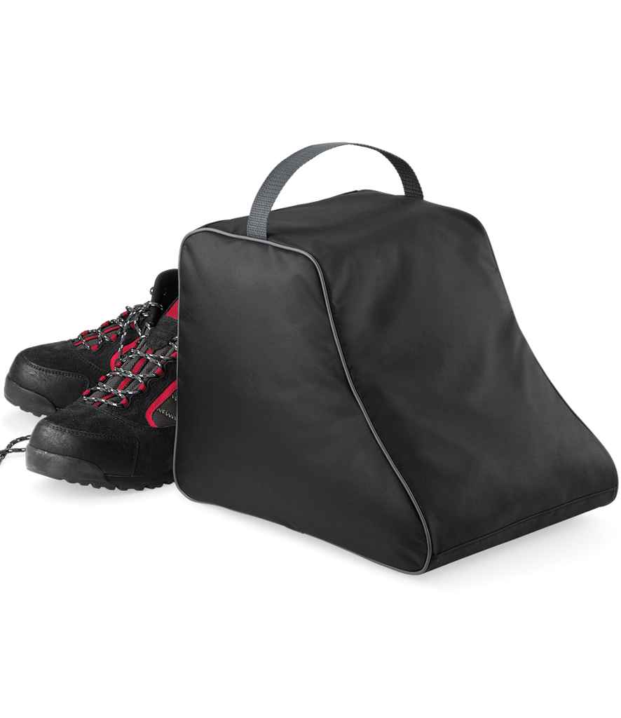 A pair of black hiking boots with red accents is placed beside the Quadra Hiking Boot Bag by Quadra, a black 420D polyester shoe bag with a zippered closure and a webbing carry handle on top.