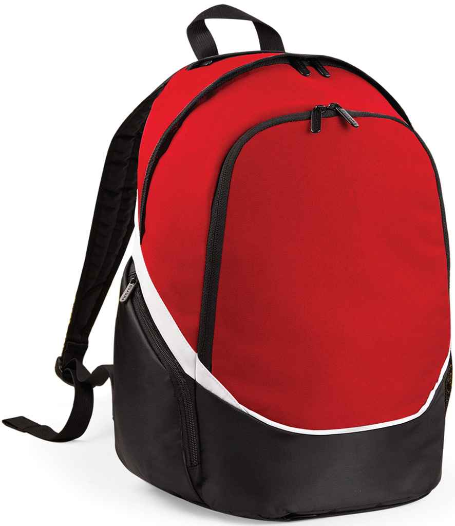 The Quadra Pro Team Backpack by Quadra, in red/black/white, features a 17L capacity, black zippers, white diagonal stripe, padded shoulder straps, adjustable black straps, and a top handle. Shown upright on a white background.