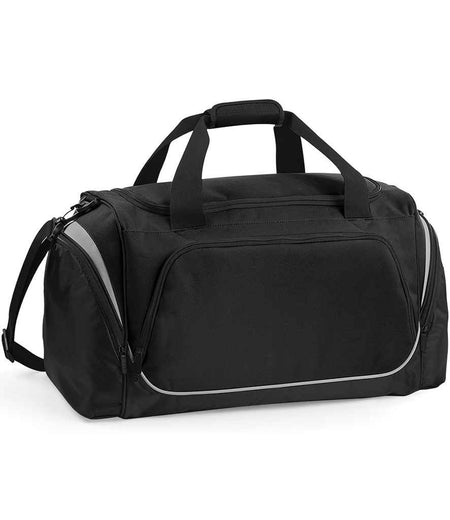 The Quadra Pro Team Holdall by Quadra in Black/Graphite Grey features dual handles, a detachable shoulder strap, front and side zippered compartments, 55L capacity, light-colored trim accents, and a handy shoe tunnel.