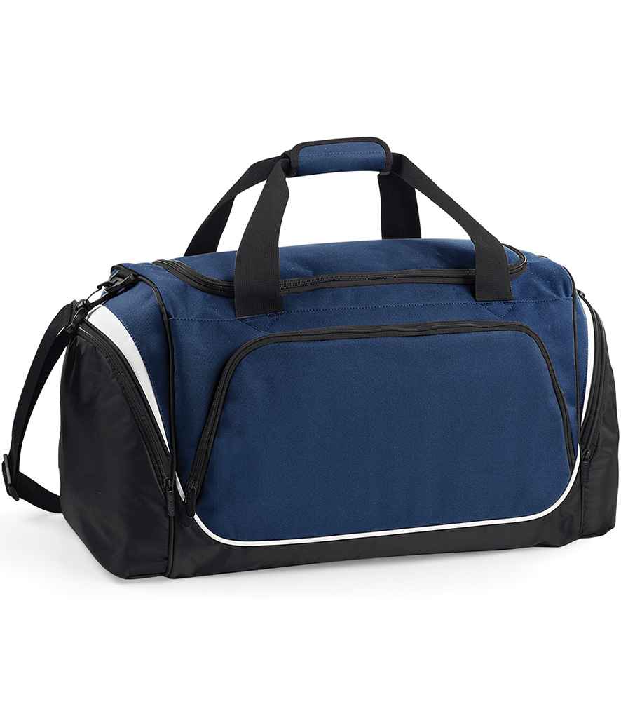 The Quadra Pro Team Holdall by Quadra, in French Navy/White, features black handles, a shoulder strap, white piping, a dedicated shoe tunnel, and multiple zippered compartments shown against a white background.