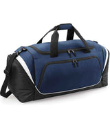 The Quadra Pro Team Jumbo Kit Bag by Quadra features French Navy/Black/White colors, black handles, a shoulder strap, multiple zippered compartments, white side accents, and a large front pocket.