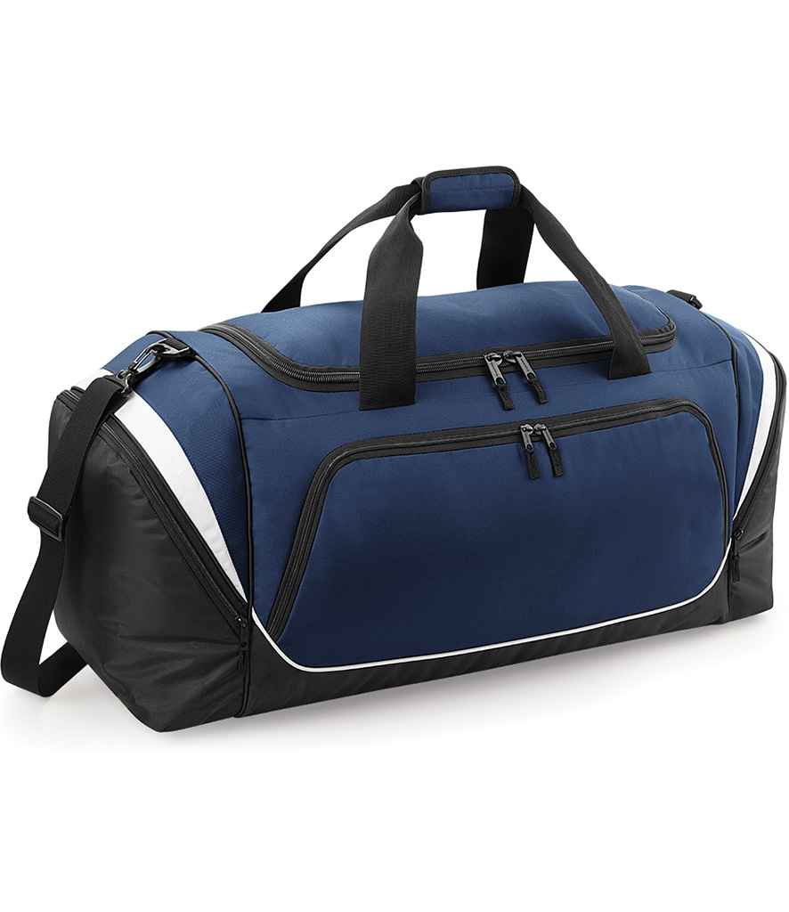 The Quadra Pro Team Jumbo Kit Bag by Quadra features French Navy/Black/White colors, black handles, a shoulder strap, multiple zippered compartments, white side accents, and a large front pocket.