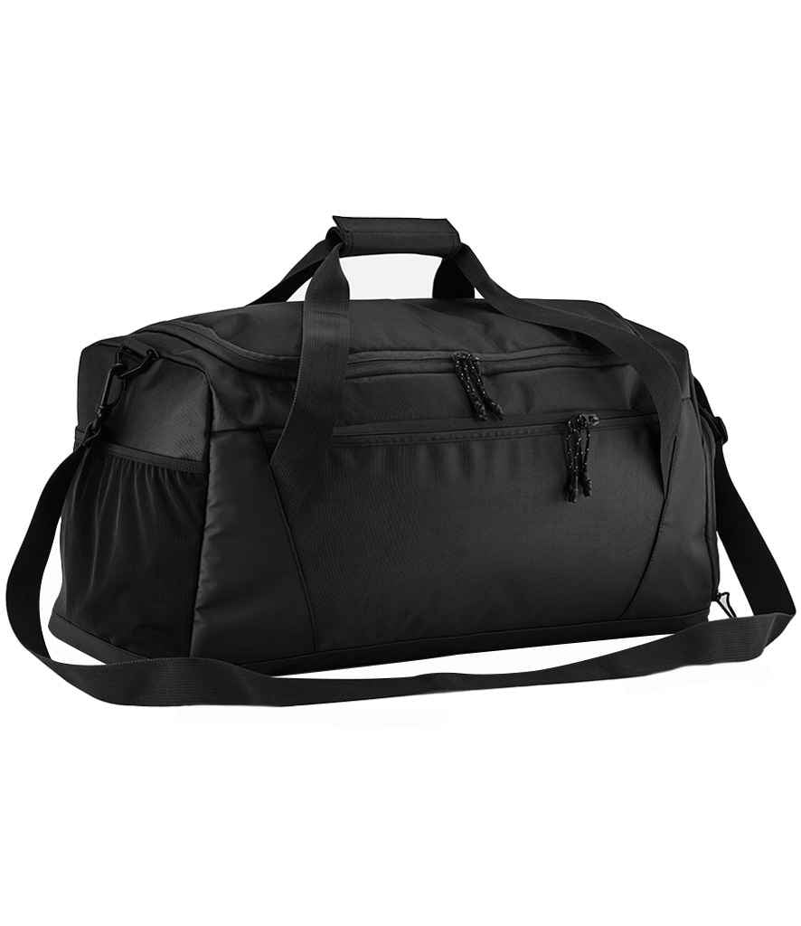 The Quadra Multi-Sport Locker Holdall by Quadra, shown in black against a white background, is made from recycled polyester and features two handles, an adjustable shoulder strap, front zippered pocket, and side pockets.