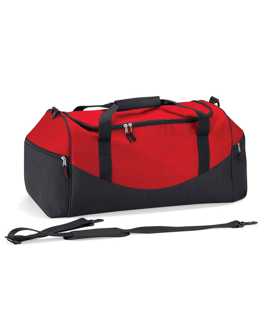 The Quadra Teamwear Holdall by Quadra is a large red/black/red duffel bag with black handles, zippers, padded hand grip, front zippered pocket, and an adjustable shoulder strap placed in front.