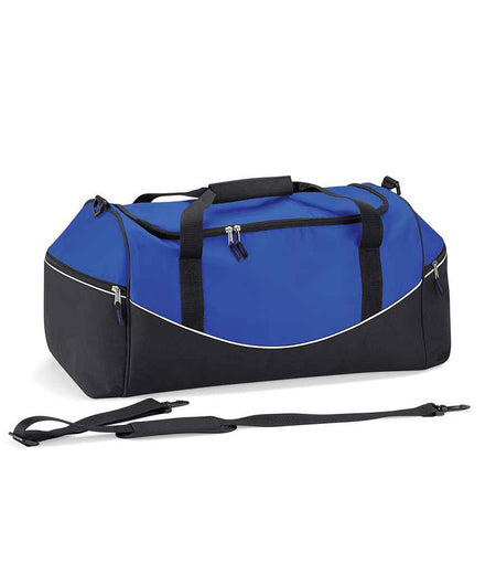 The Quadra Teamwear Holdall by Quadra is shown in royal blue/black/white with black handles, zippers, a detachable shoulder strap, curved white piping, padded hand grip, multiple zippered compartments, and large end pockets.