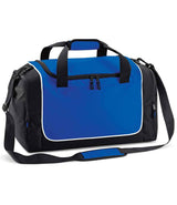 The Quadra Teamwear Locker Bag by Quadra in Royal Blue/Black features black straps, a front zipper pocket, side mesh pocket, adjustable shoulder strap, white piping detail, top carrying handle and a 30L capacity.