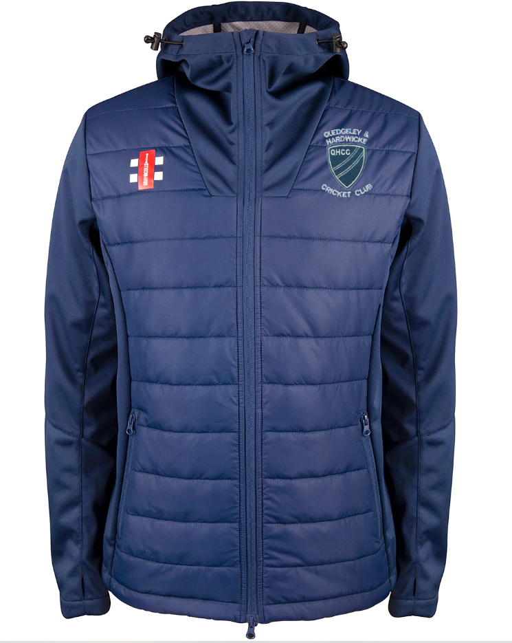 The Gray Nicolls Quedgeley & Hardwicke CC Pro Performance Jacket is navy blue, water repellent, hooded, with a front zipper and two zip pockets. It features the club logo on the left chest and a small red and white emblem on the right.