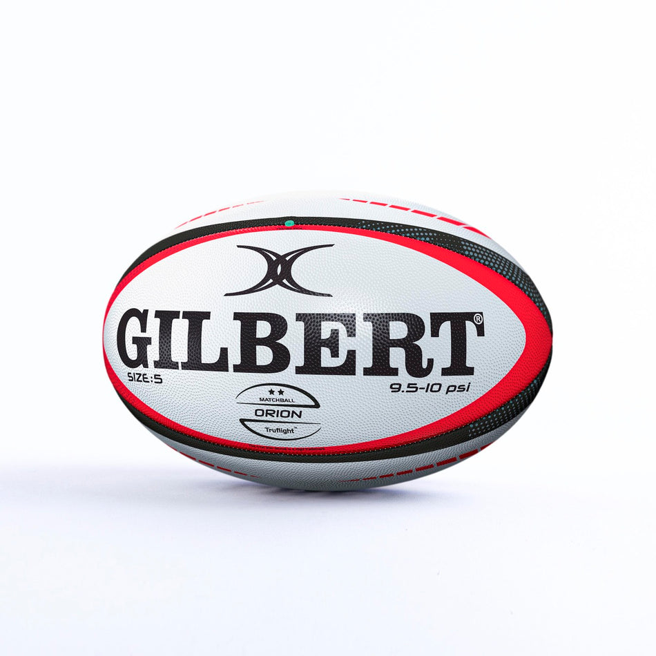 The Gilbert Orion Match Rugby Ball by Gilbert, in black/red, features bold logos and text. Hand stitched and designed for official World Rugby matches, it’s displayed on a plain white surface with a white background.