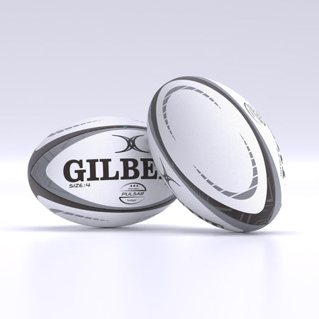 Two white and gray Gilbert Pulsar Match Rugby Balls, hand stitched to meet World Rugby specs, rest on a clean light surface—one upright, the other leaning gently against it.
