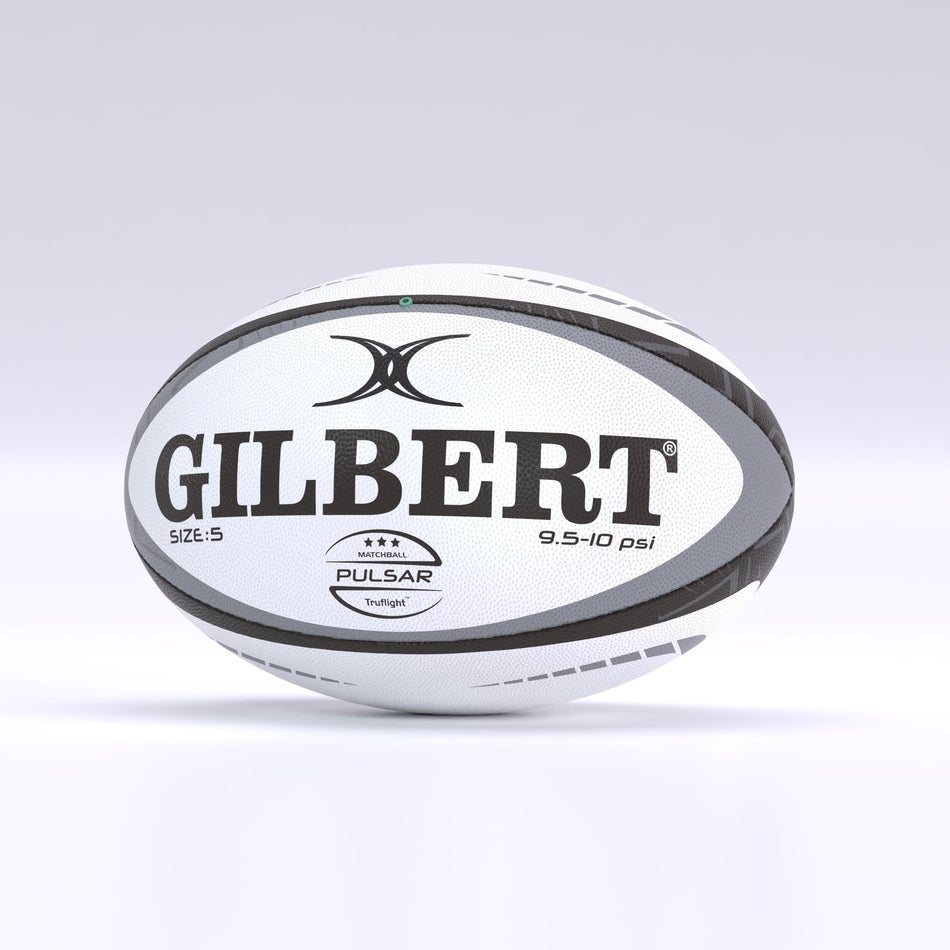 The Gilbert Pulsar Match Rugby Ball, white with black and gray details, features hand stitching to World Rugby specs, brand logos, size 5 and 9.5-10 psi text. It rests on a light gray surface.