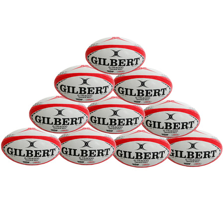 A pyramid stack of ten red Gilbert G-TR4000 Rugby Balls by Gilbert, arranged in four rows against a white background—perfect as a rugby training ball display.