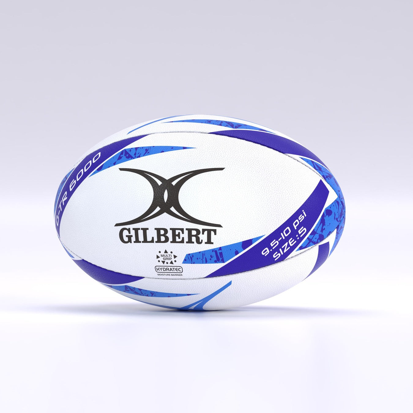 A white Gilbert G-TR6000 Training Rugby Ball with blue and purple accents rests on a light background. Its durable rubber surface makes it perfect for schools and clubs.
