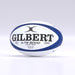A navy Gilbert G-TR8000 Training Rugby Ball by Gilbert is displayed on a plain light background, featuring large black branding and text that identifies it as a size 5 ball crafted from durable rubber.