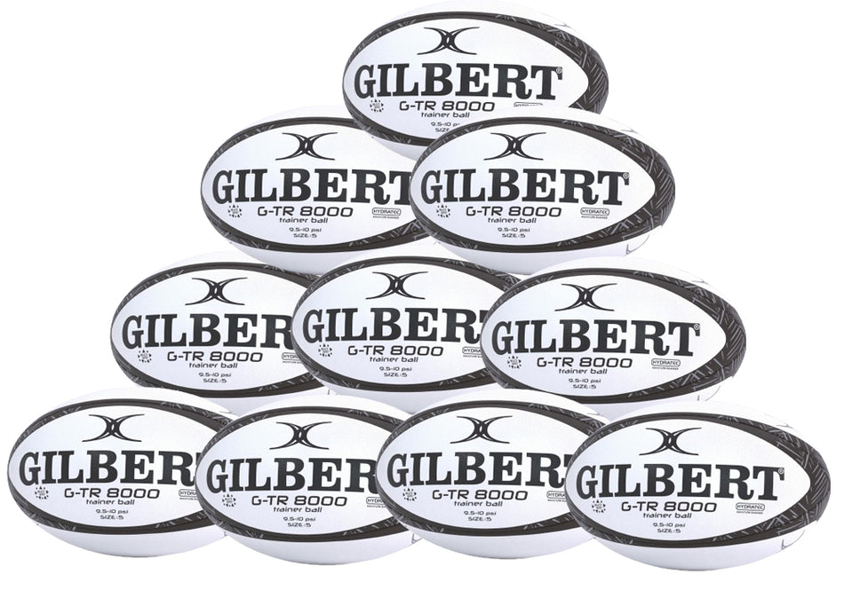 Ten black Gilbert G-TR8000 Training Rugby Balls from the Ten Pack are stacked in a pyramid shape, each displaying the Gilbert brand name and model number on the front.