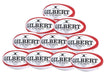 A pyramid stack of ten red Gilbert G-TR8000 Training Rugby Balls, each featuring the brand name in bold, ideal for clubs seeking a reliable UK rugby ball option.