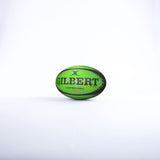 A green Gilbert Control-A-Balls - Singles rugby ball with black text, from the Gilbert training range, stands upright on a white background.