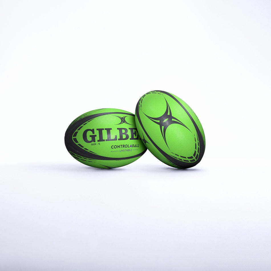 Two green and black Gilbert Control-A-Balls - Singles by Gilbert are shown on a white surface—one upright, one lying down—making them ideal quality rugby training equipment to improve your catch pass system.