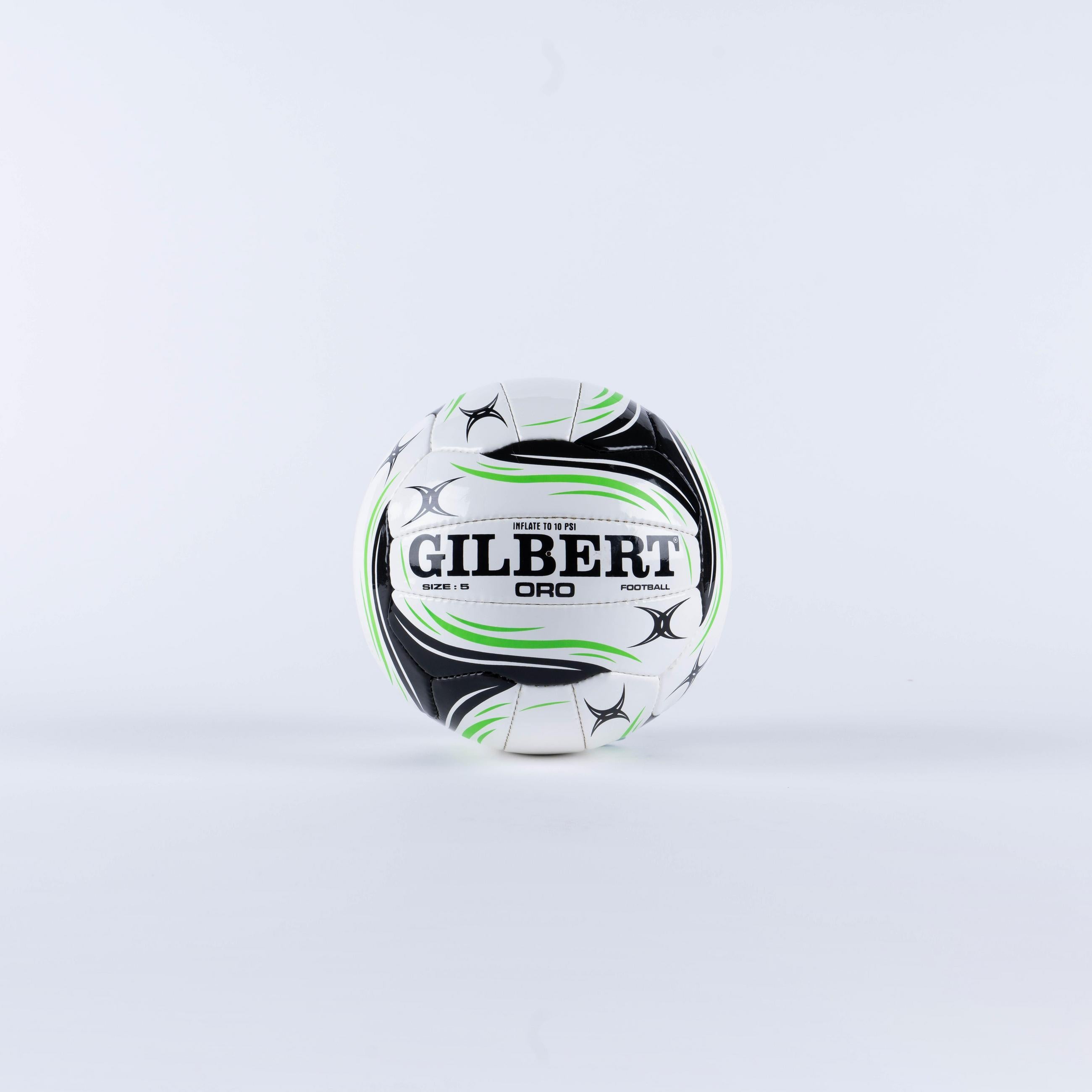 The Gilbert Oro Football, Size 5, by Gilbert is shown in white with green and black accents on a light gray background. "GILBERT" is boldly printed at the center—perfect for club and school football games.