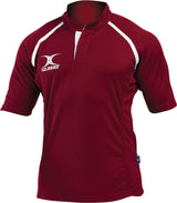 The Gilbert Xact Match Monochrome Rugby Shirt is a maroon short-sleeve top with white piping, a button placket, and the Gilbert logo on the left chest. Designed for comfort and moisture management, it's ideal durable sportswear.
