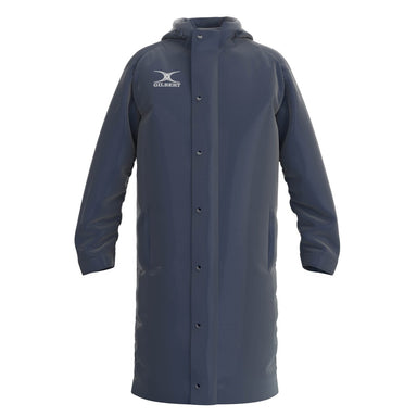 The Gilbert TTS Touchline Jacket is a long, dark navy waterproof coat with a hood, snap-button front, two side pockets, and the Gilbert logo on the chest.