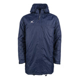 The Gilbert TTS All Weather Jacket by Gilbert is a dark navy, hooded, long waterproof jacket made from recycled polyester with a front zipper, side pockets, adjustable drawstring hem, and a white logo on the left chest.