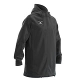 The Gilbert TTS All Weather Jacket by Gilbert is a long, black waterproof jacket made from recycled polyester with a front zipper, drawstring hood and hem, white chest logo, long sleeves, and a relaxed fit.