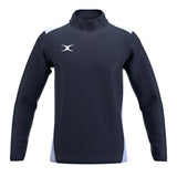 The Gilbert Atom Warm Up Jacket by Gilbert is a long-sleeve navy pullover made from recycled polyester, with a high collar, light blue side panels, and a white left-chest logo. Shown as versatile training outerwear on a plain white background.