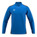 The Gilbert Atom Warm Up Jacket is a blue, long-sleeve athletic jacket with dark side panels, a high collar, and a white Gilbert logo on the left chest. It’s shown on a plain white background.
